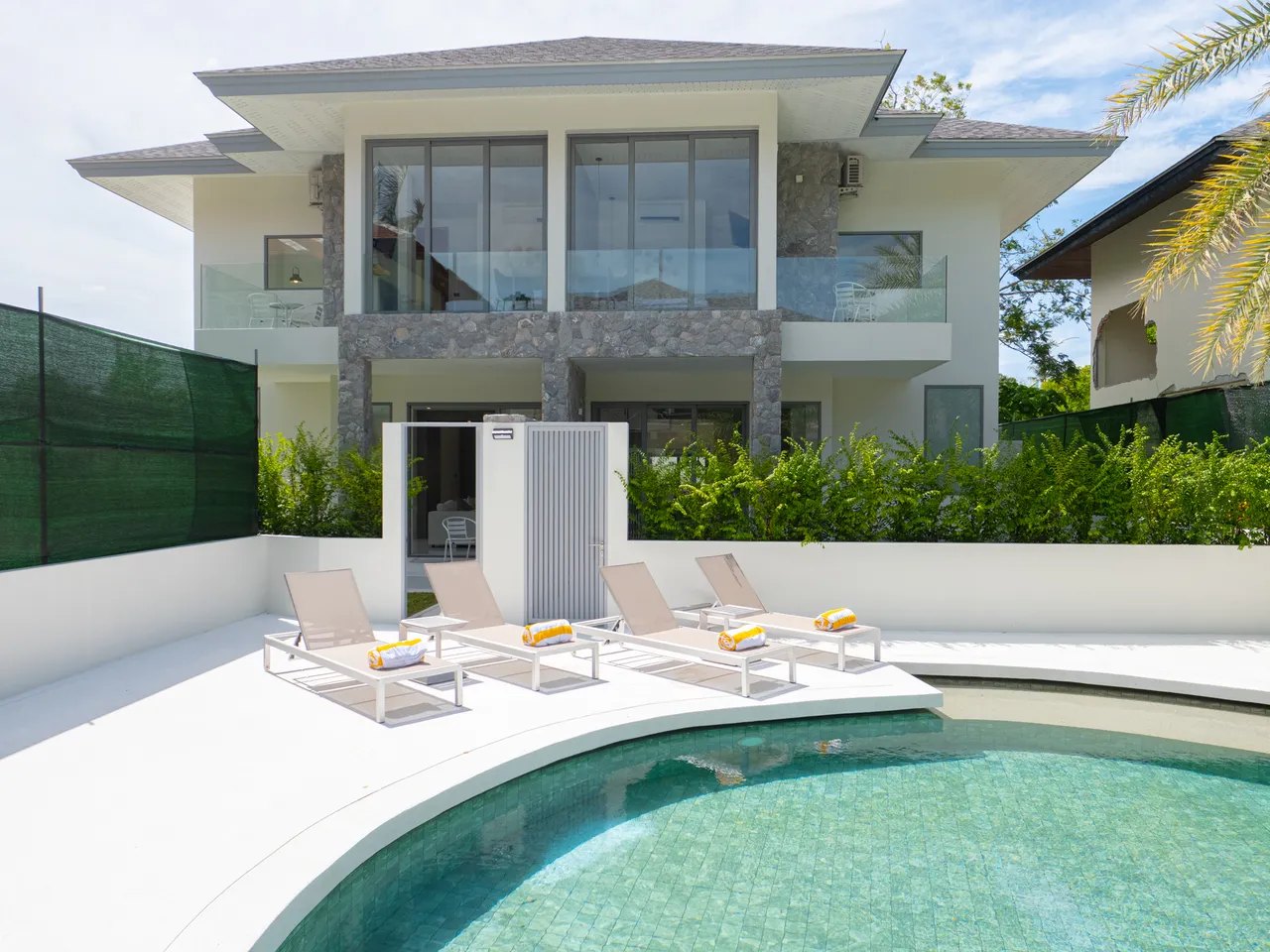 Two of the villas seen across the communal pool