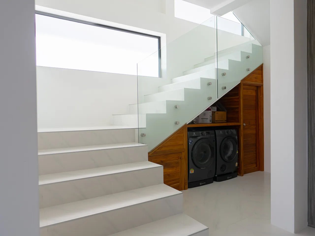 The staircase, with the laundry underneath it