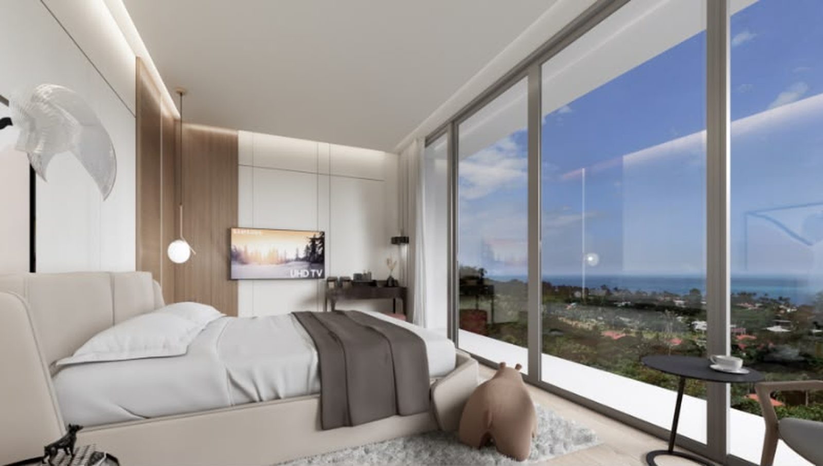 Bedroom with full-height glass onto the sea