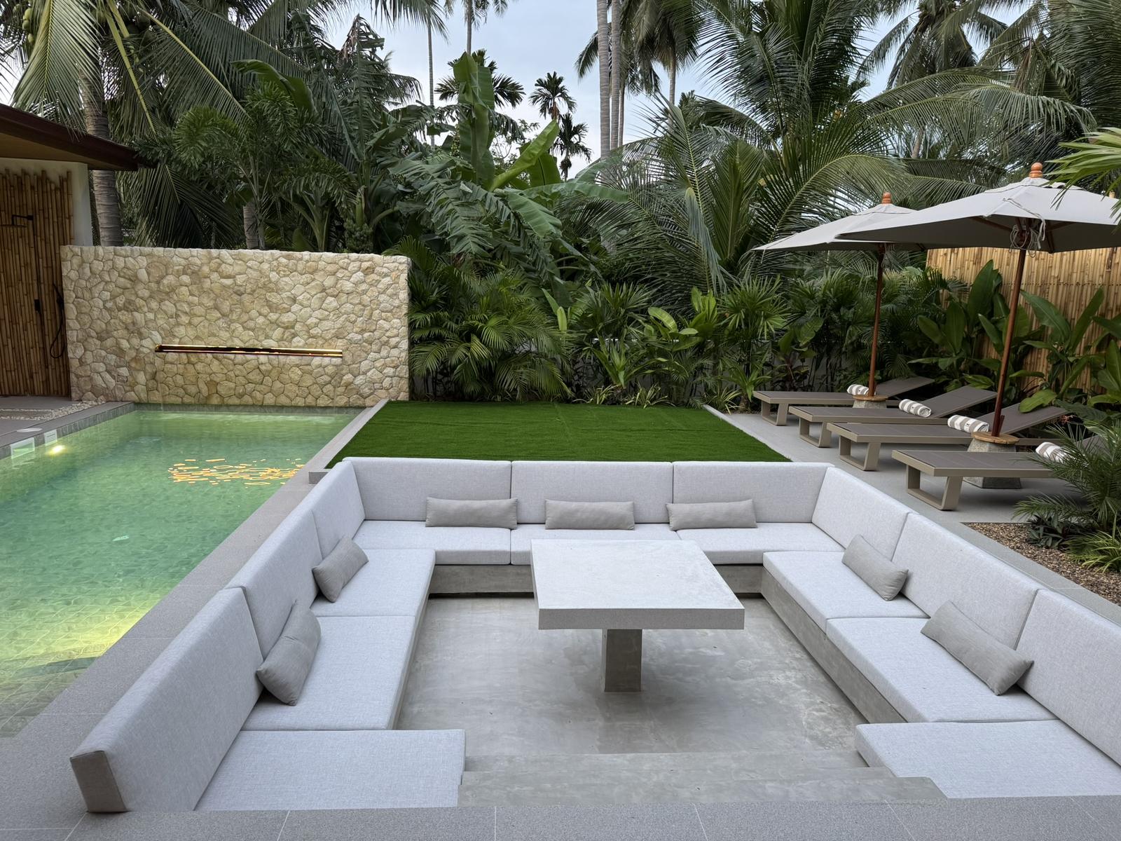 Sunken outdoor lounge beside the pool and lawn