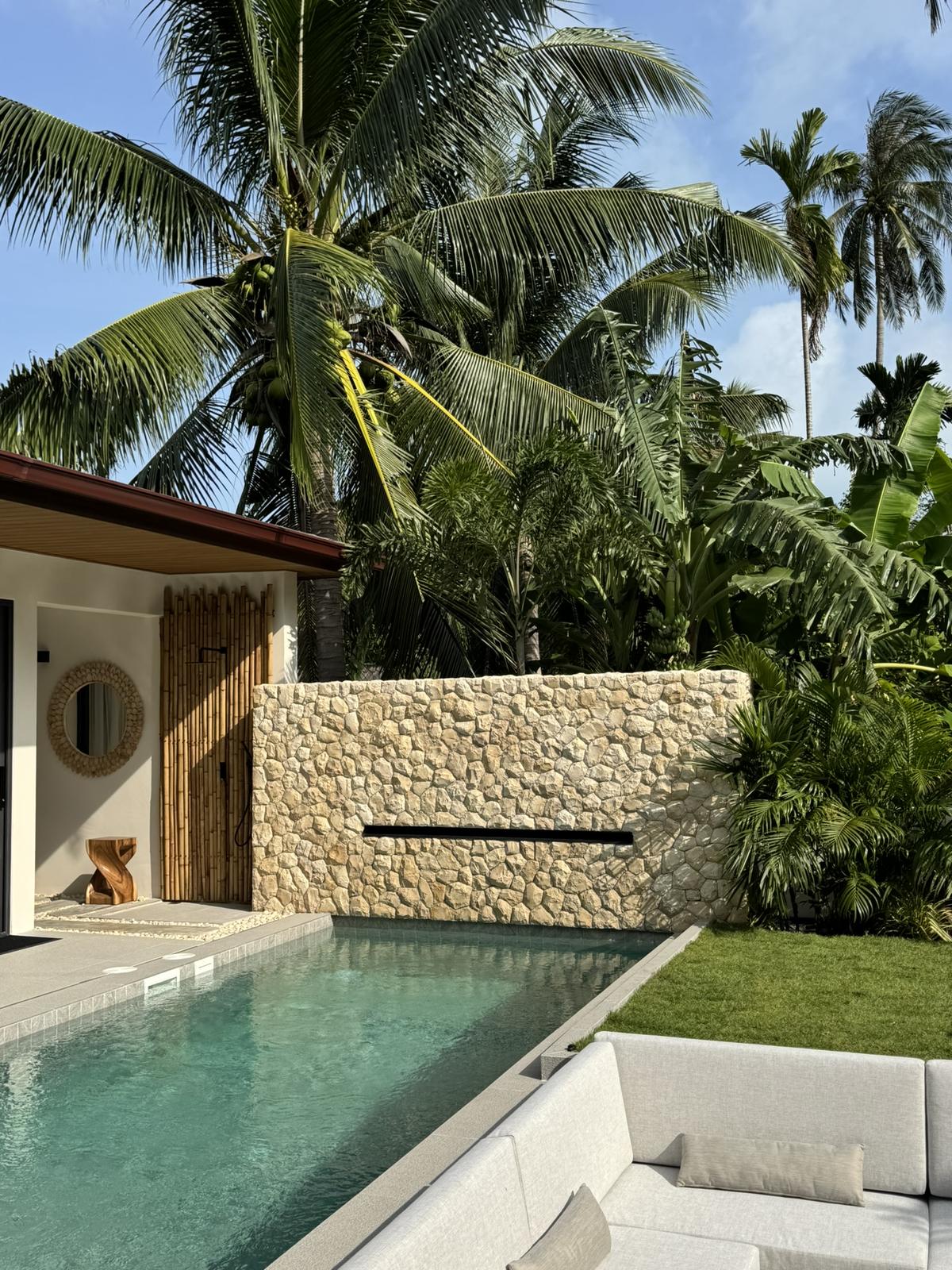 The villa seen across the pool from the garden