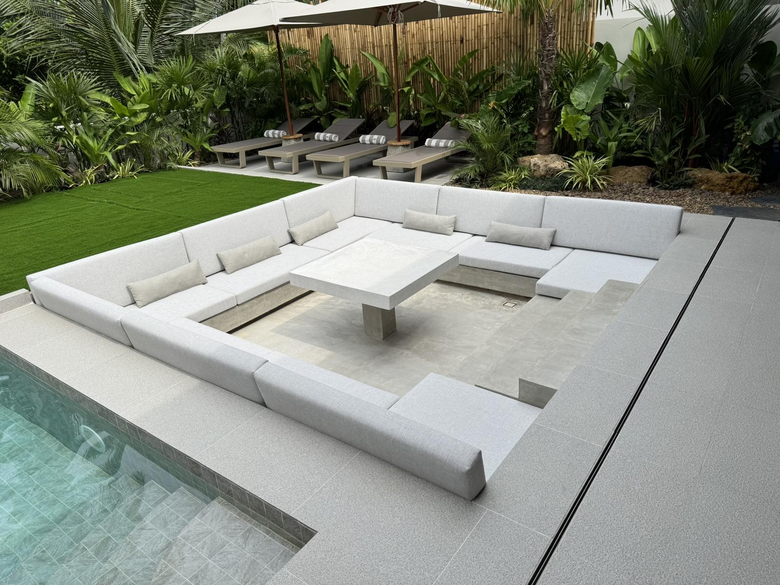Pool terrace with sun loungers and parasols