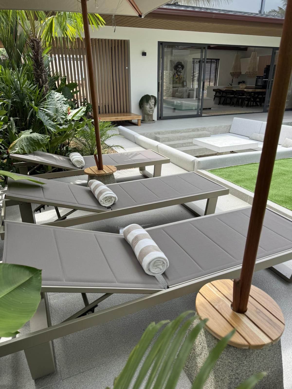 Sun loungers set out beside the pool