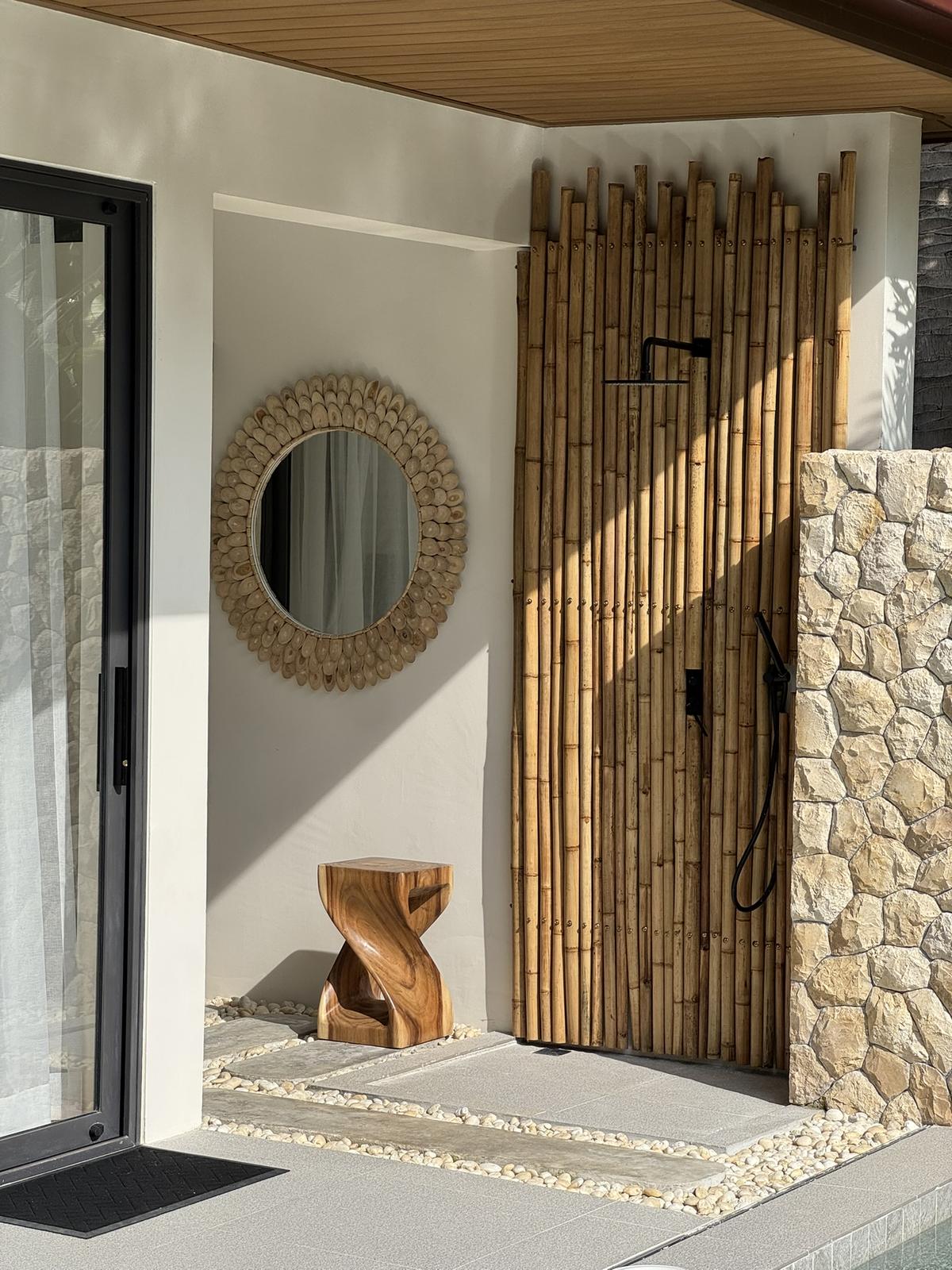 Entrance with a bamboo screen and stone wall