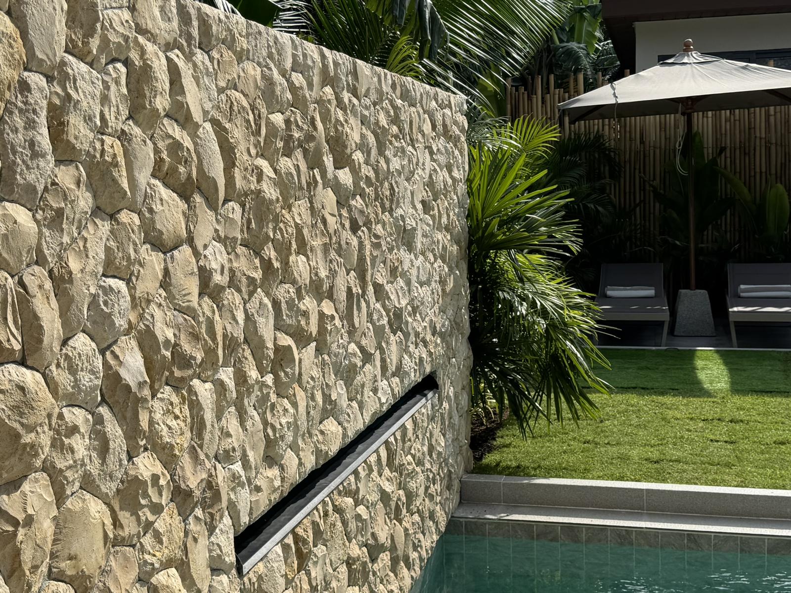 Stone garden wall beside the lawn