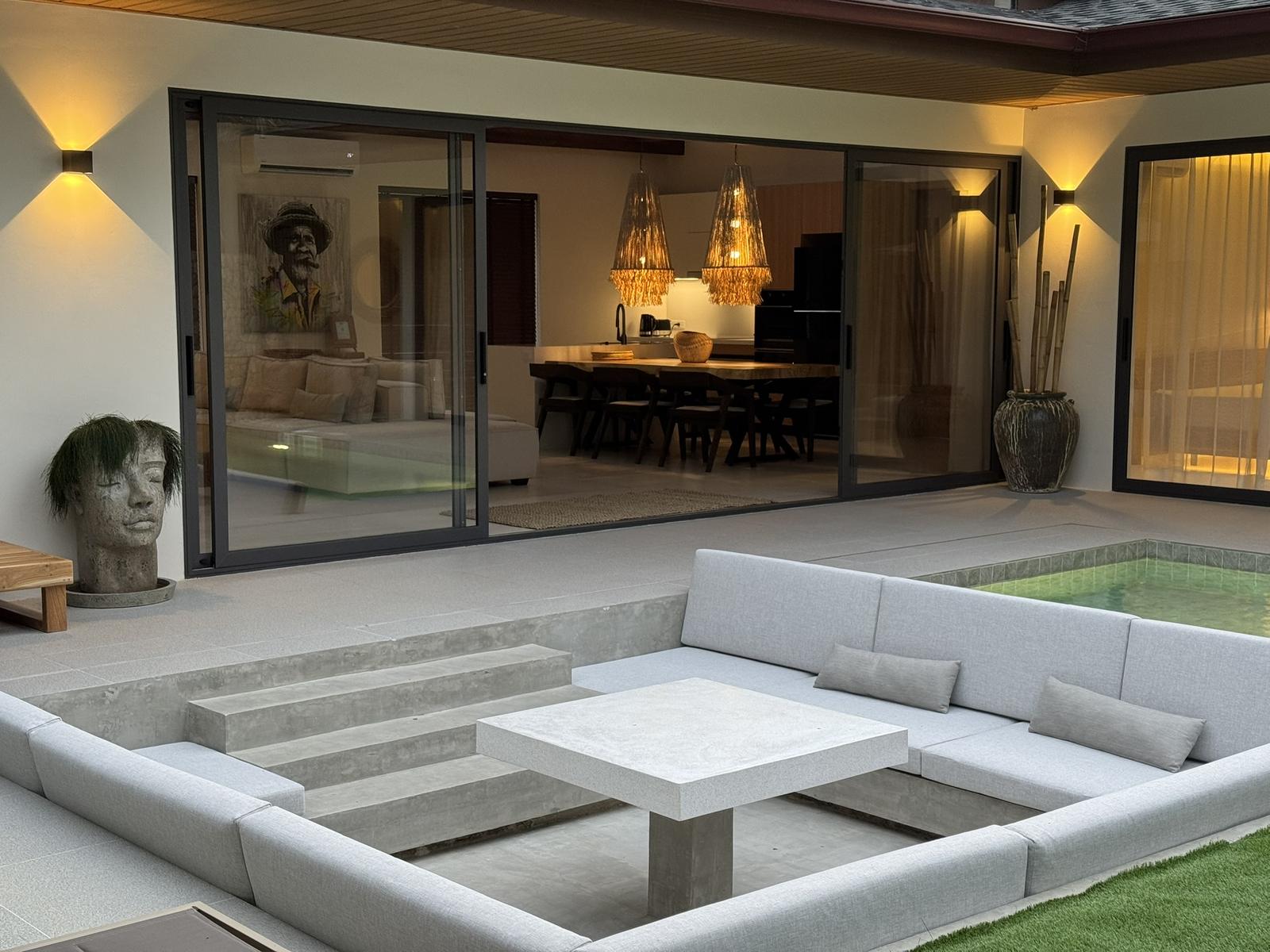 Living room opening to the sunken lounge and pool