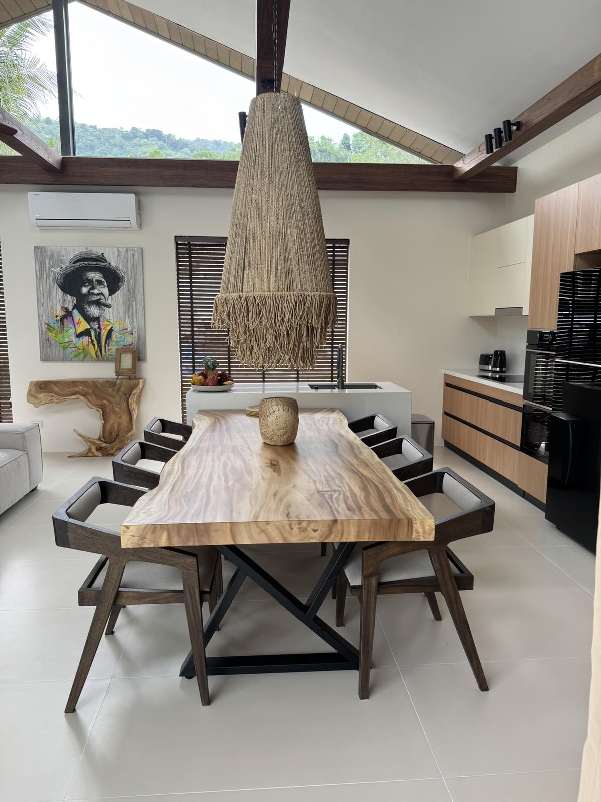 Dining table and kitchen in warm timber