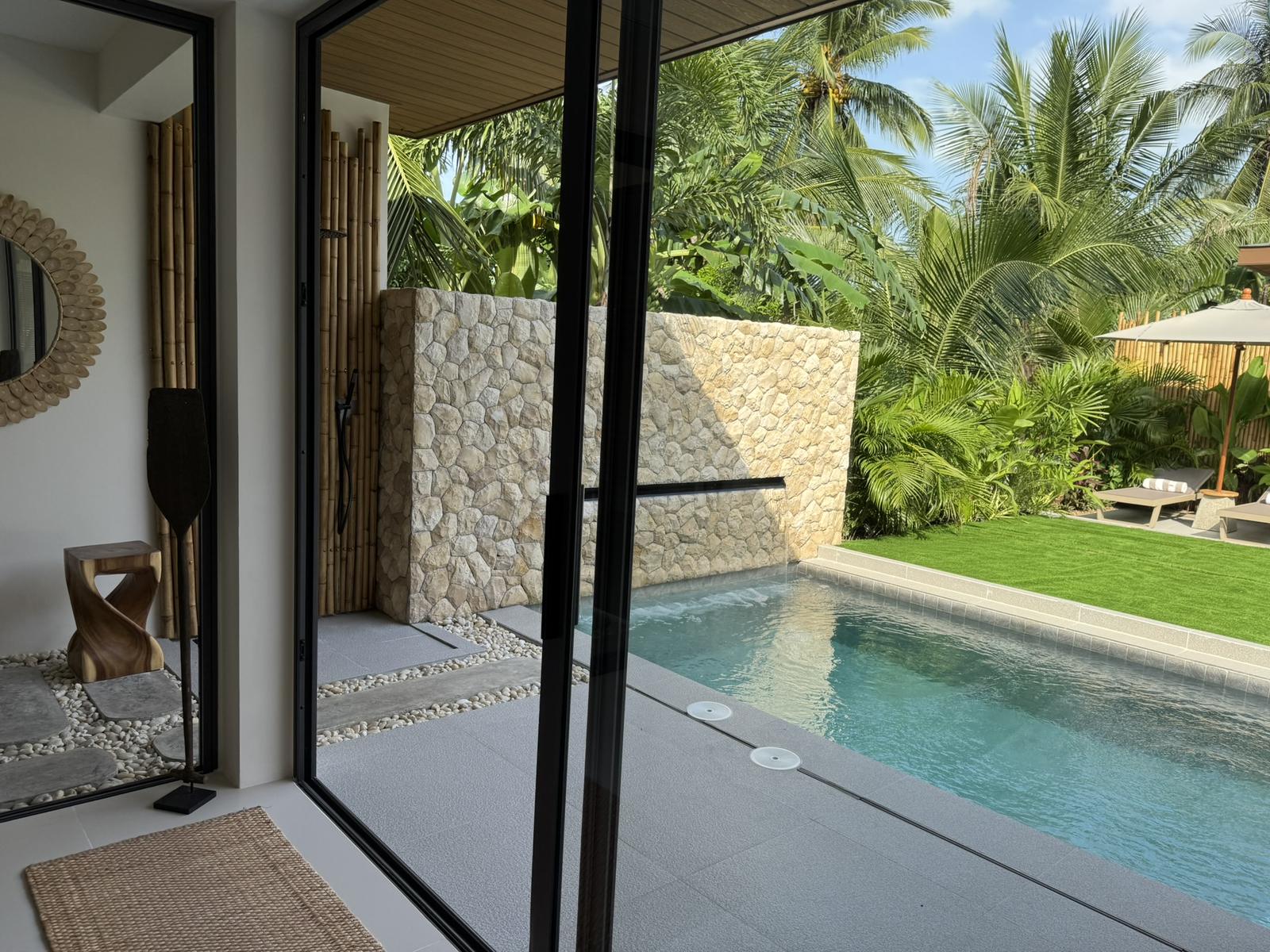 Sliding doors opening from the interior to the pool