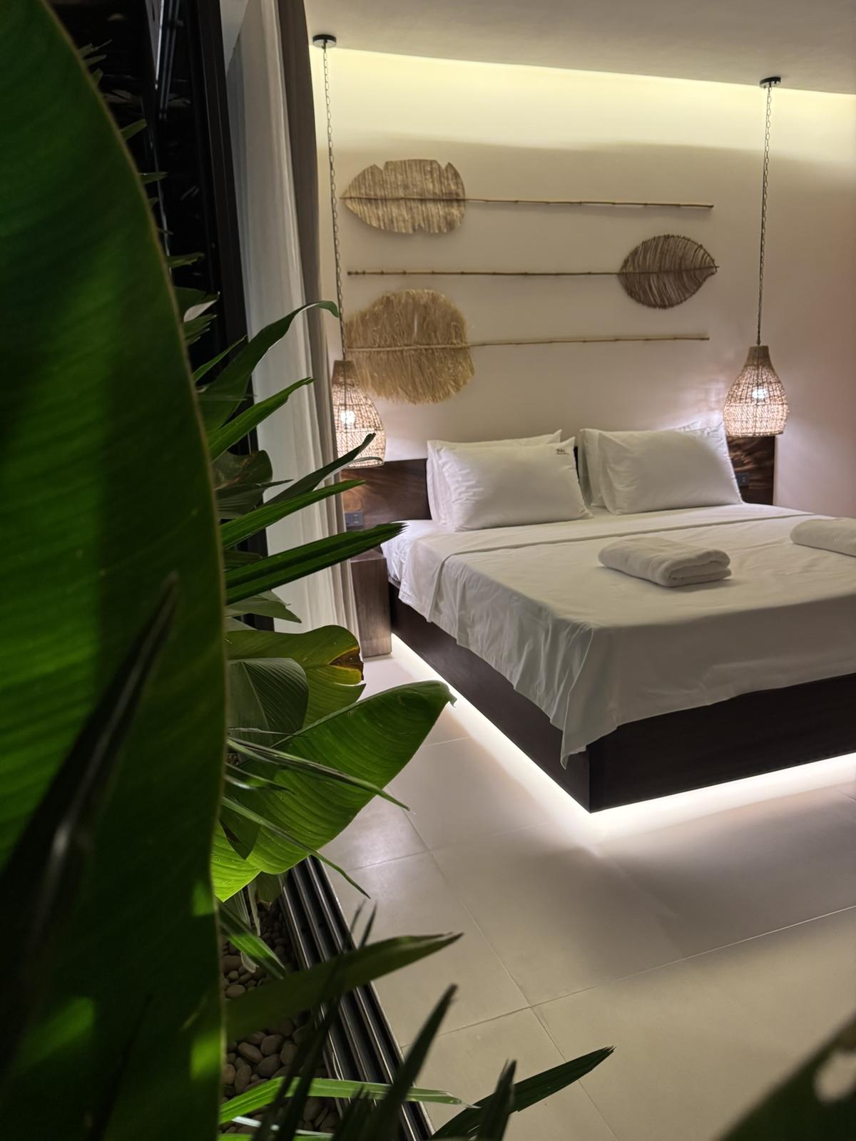 Bedroom with recessed lighting and tropical planting outside