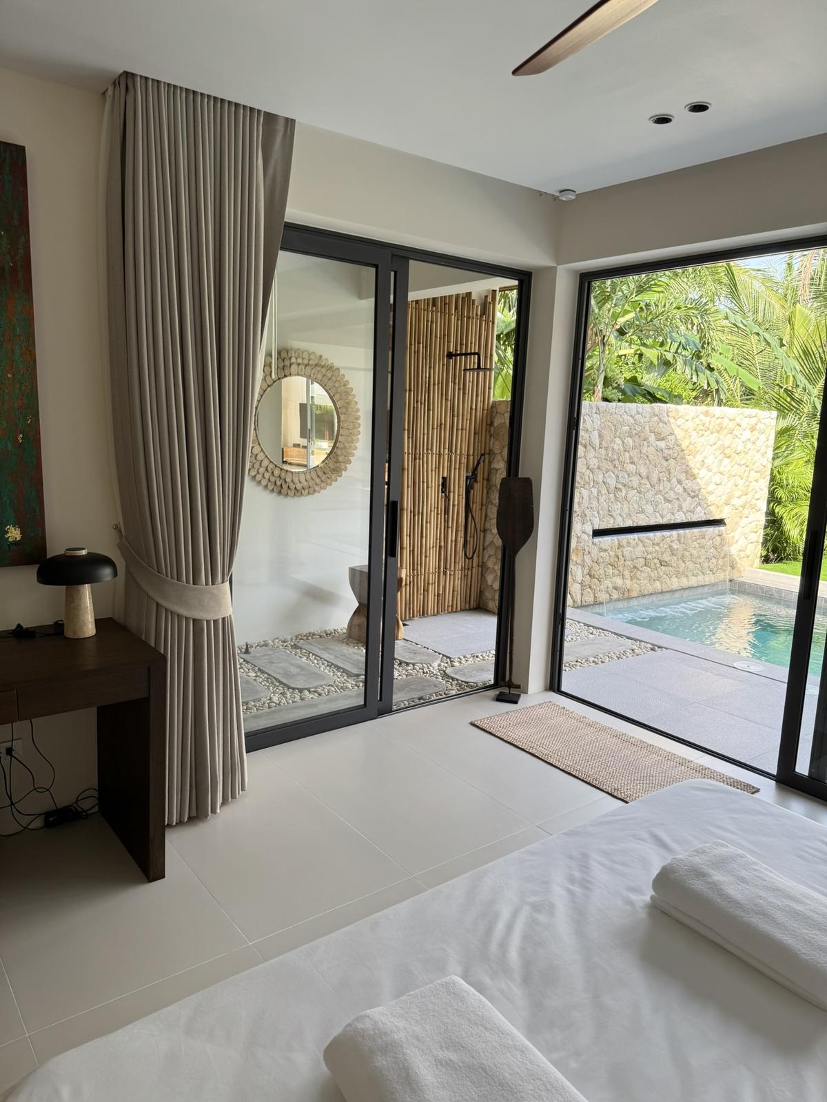 Bedroom opening to the pool and an outdoor shower