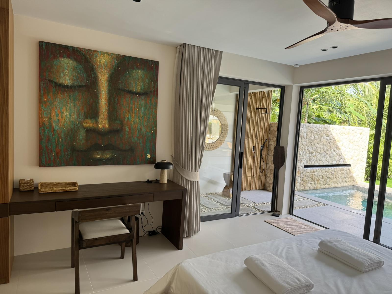 Bedroom with a dressing desk and doors to the terrace