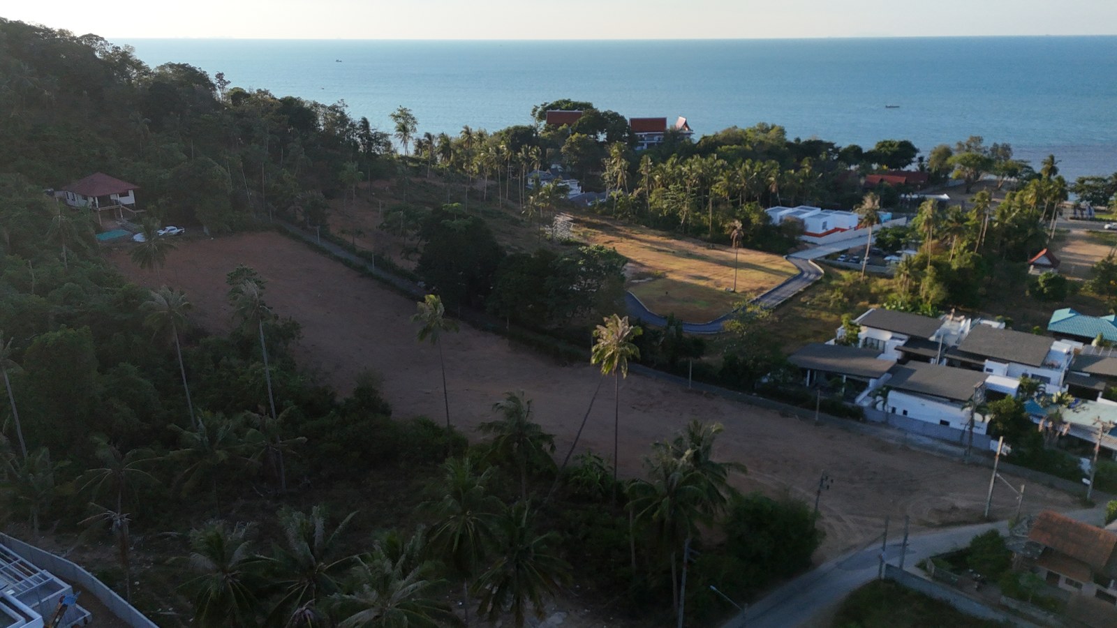 The site from the air, the north-west coast and the sea behind it