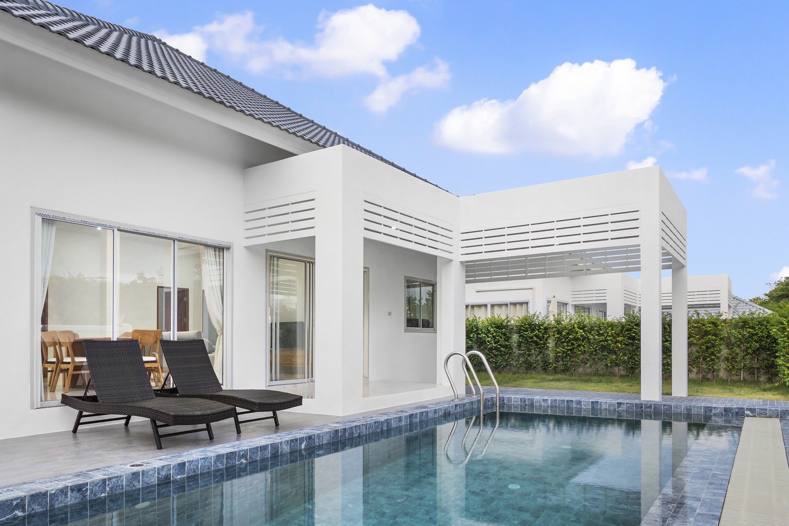 The private pool and the covered terrace of a villa in daylight