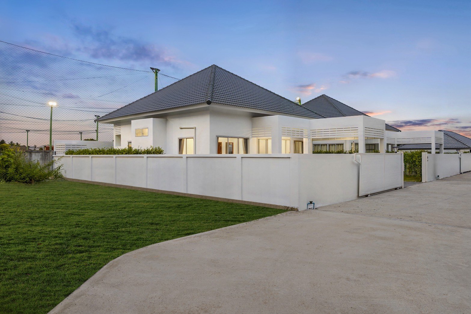 The row of villas behind their white walls at sunset