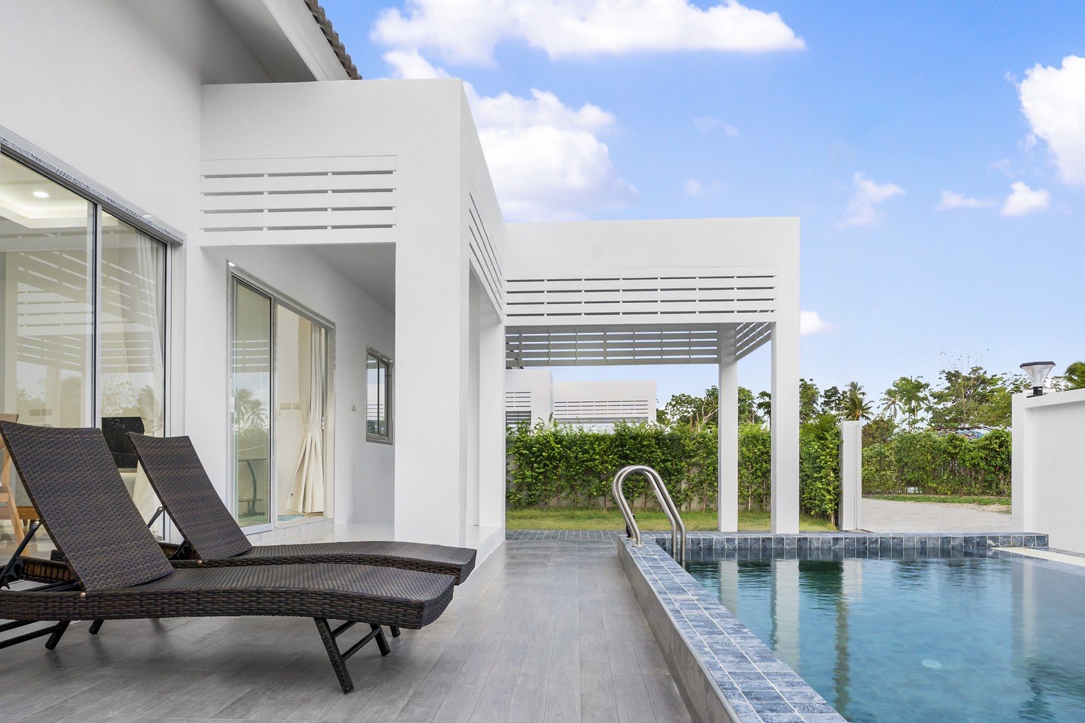 Pool terrace with loungers under a clear sky