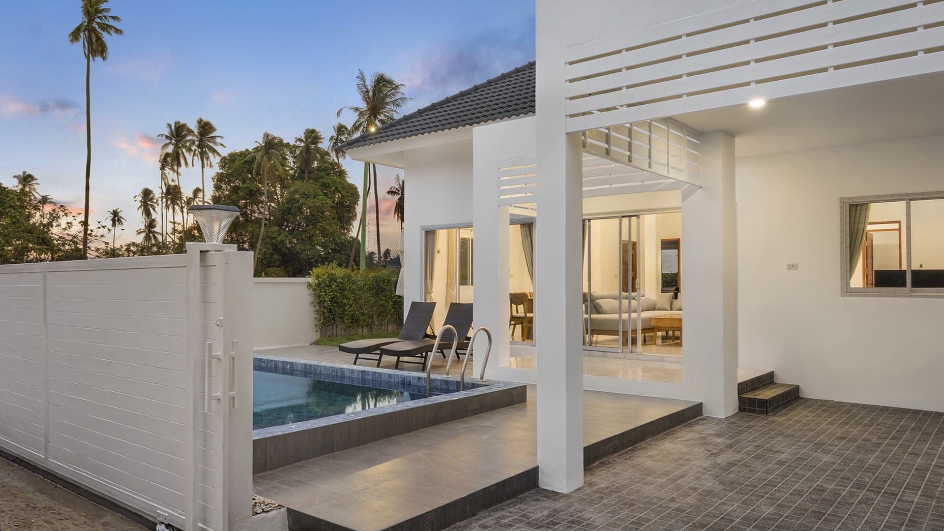 The private pool and the covered terrace of a villa in daylight