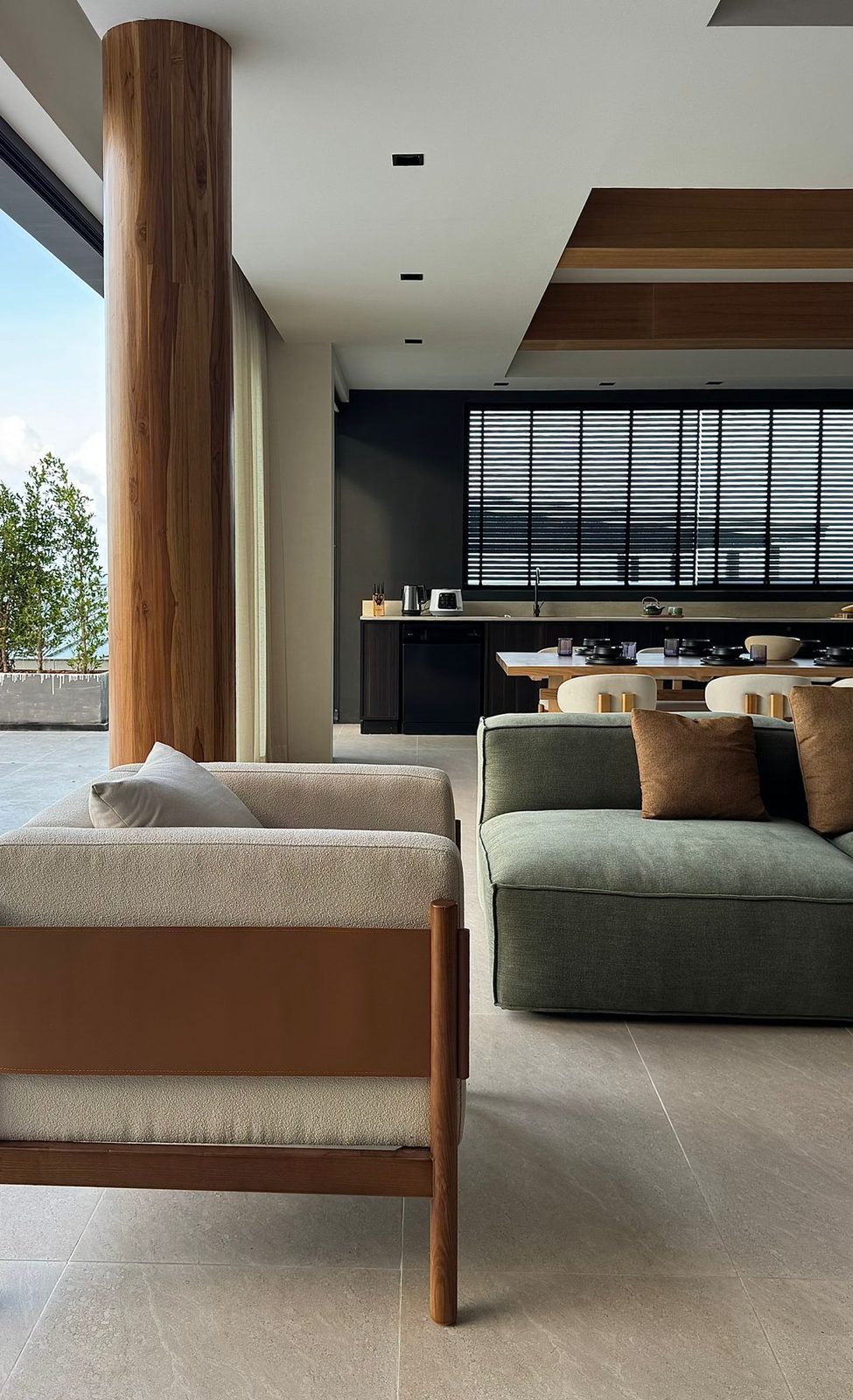 Living area with a timber column opening to the kitchen