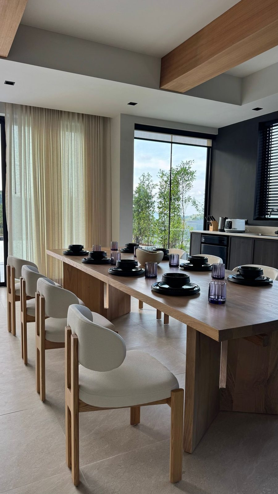 Dining area beside floor-to-ceiling windows