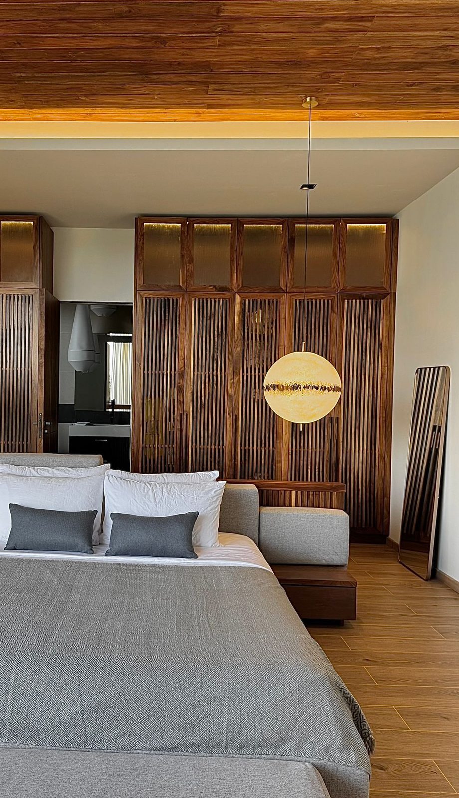 Bedroom with a timber screen and warm lighting