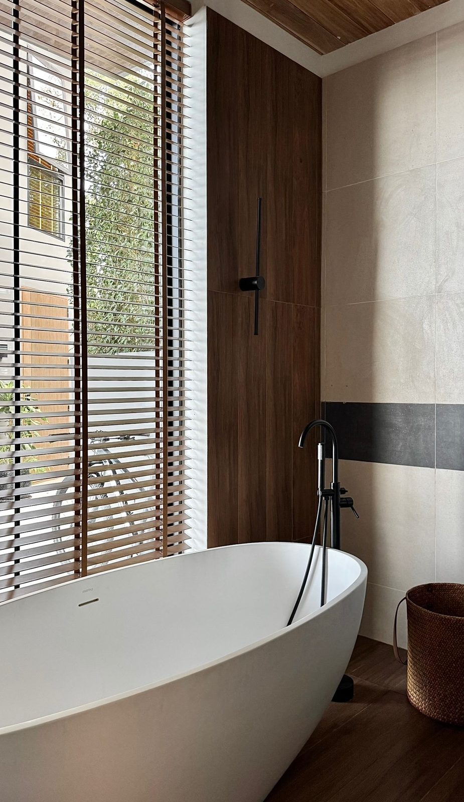Bathroom with a freestanding bathtub and timber blinds