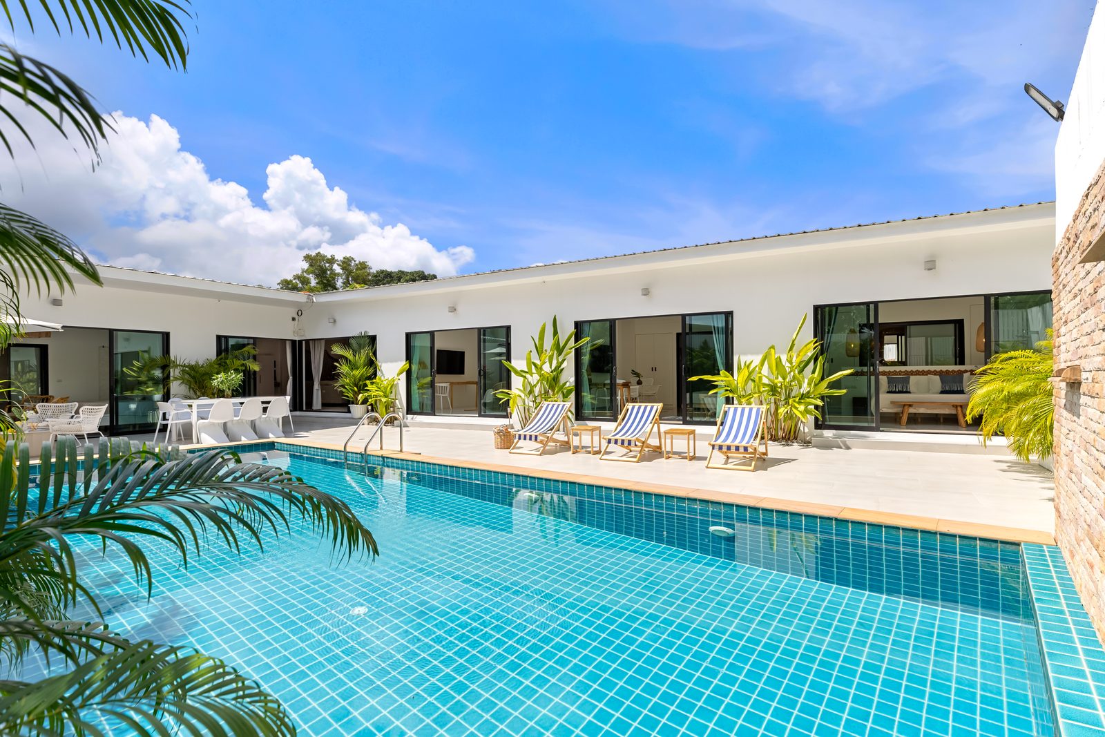 The pool terrace and the bedroom wings, each room opening onto the water