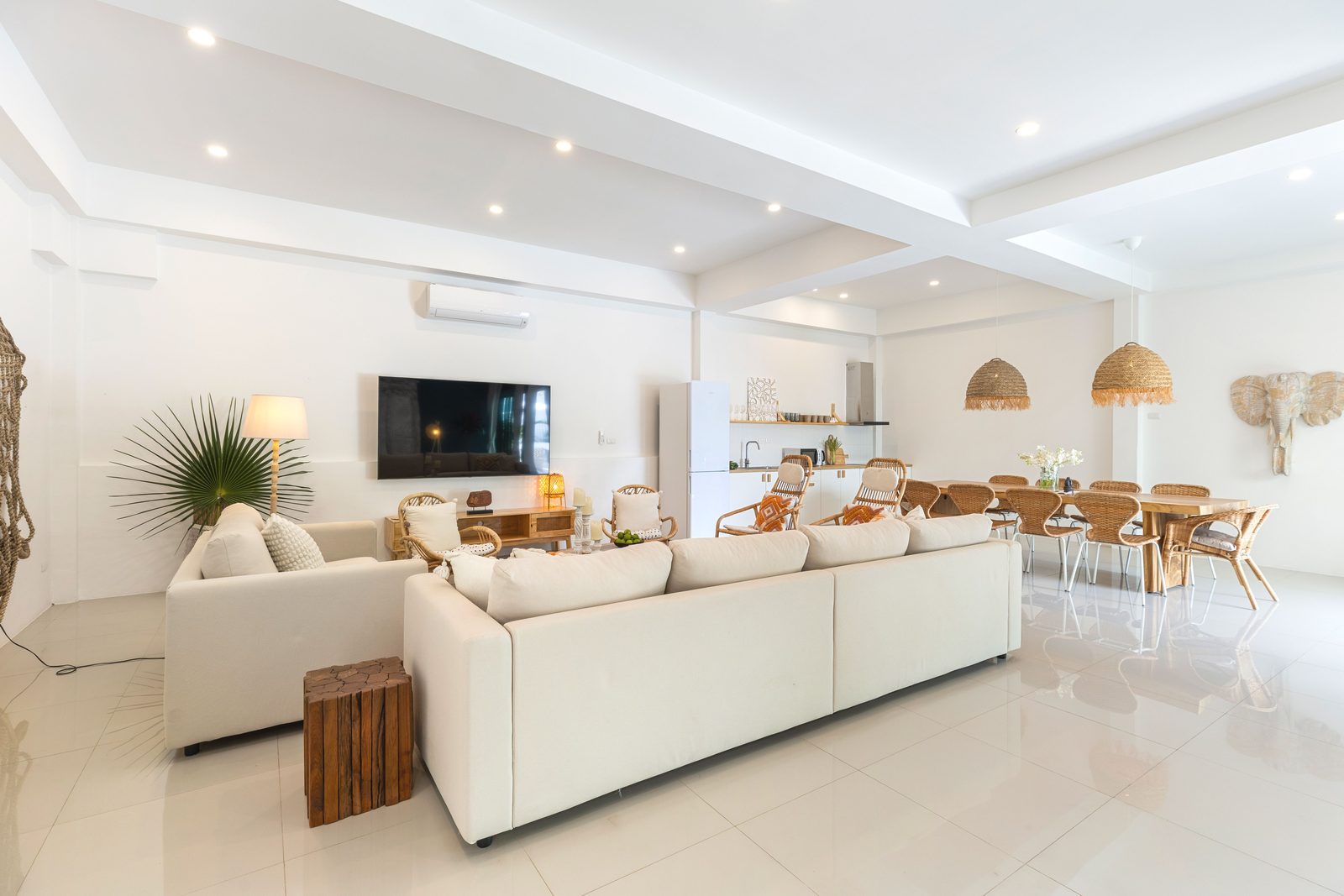 Living room with white sofas and the dining table beyond