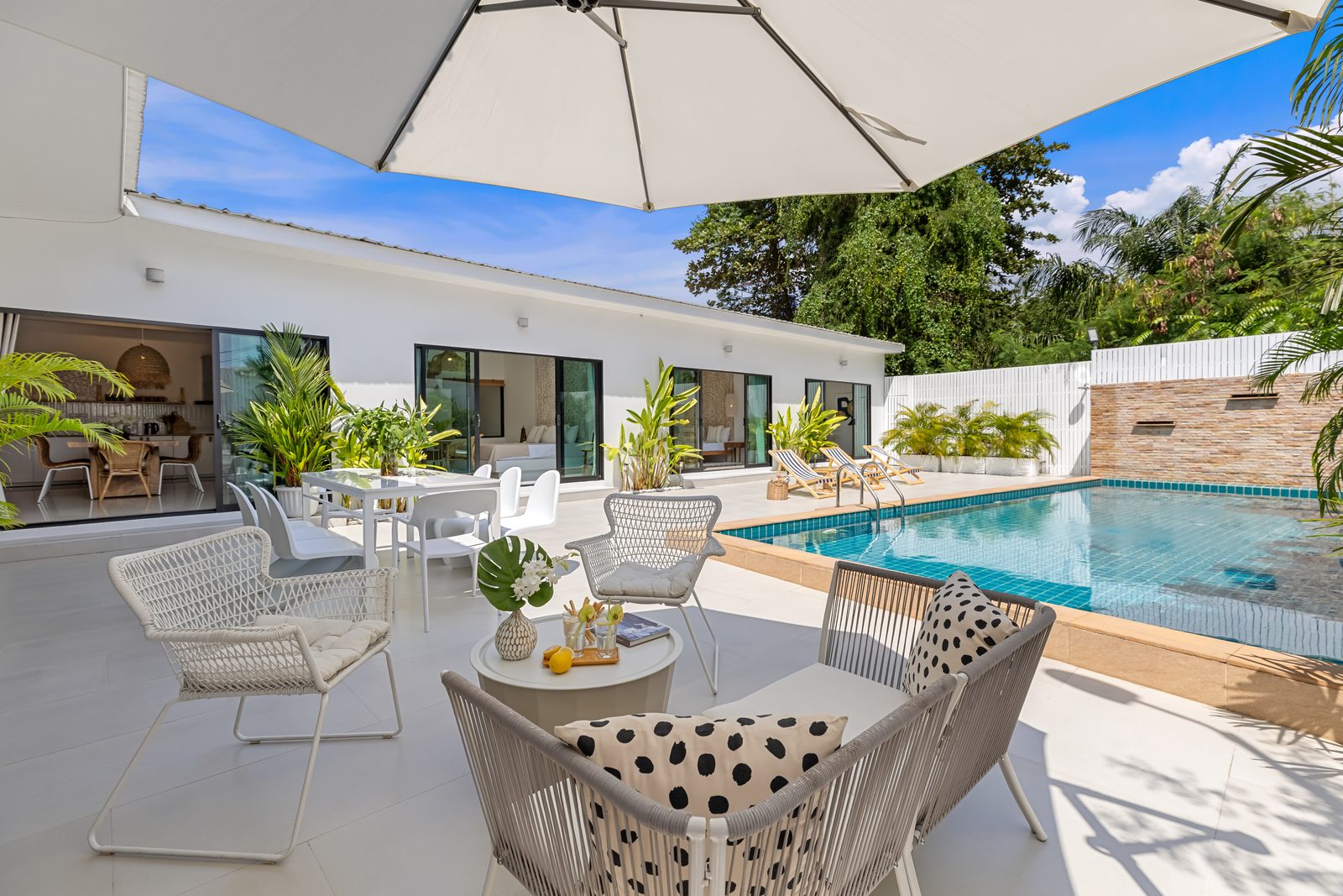 Outdoor dining under the parasol beside the pool