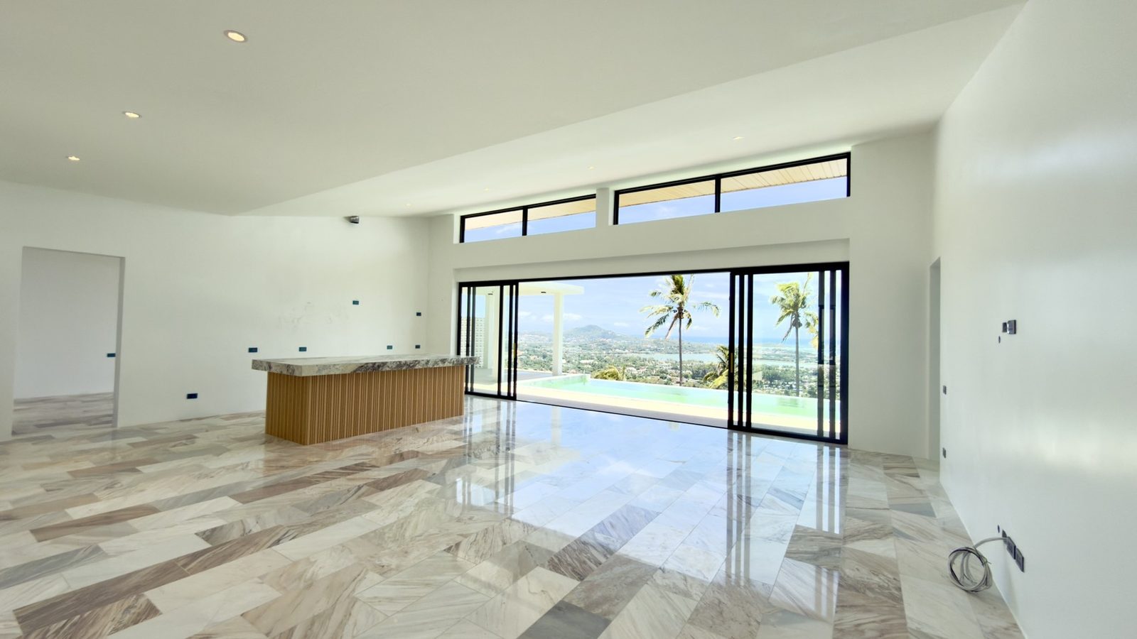 The kitchen, dining and living space as built, marble floors laid