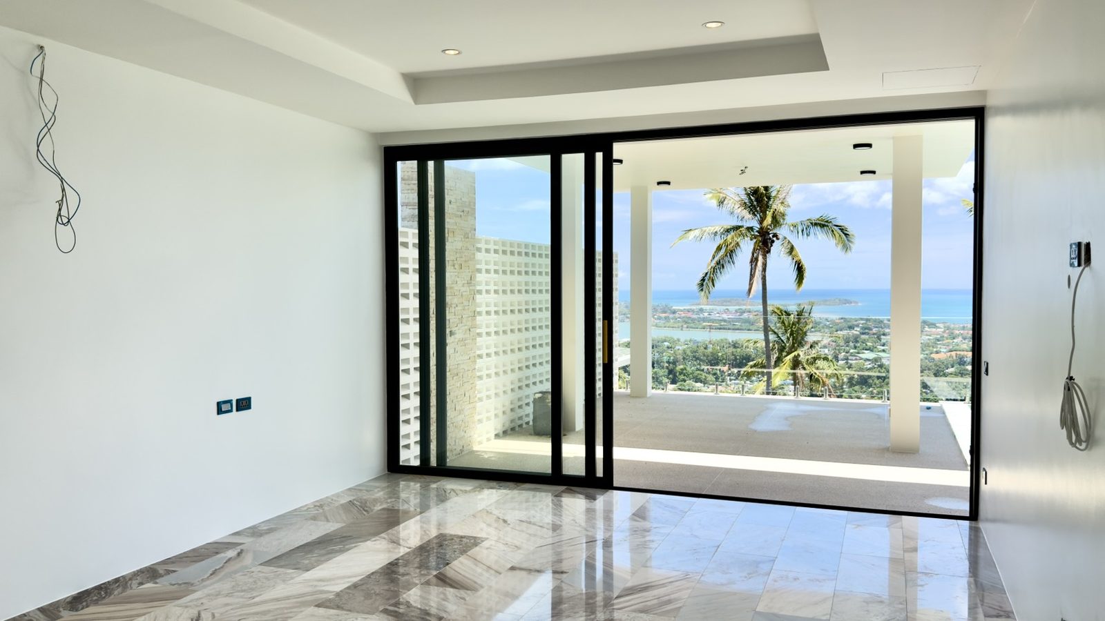A bedroom as built, sliding doors to the balcony and the sea