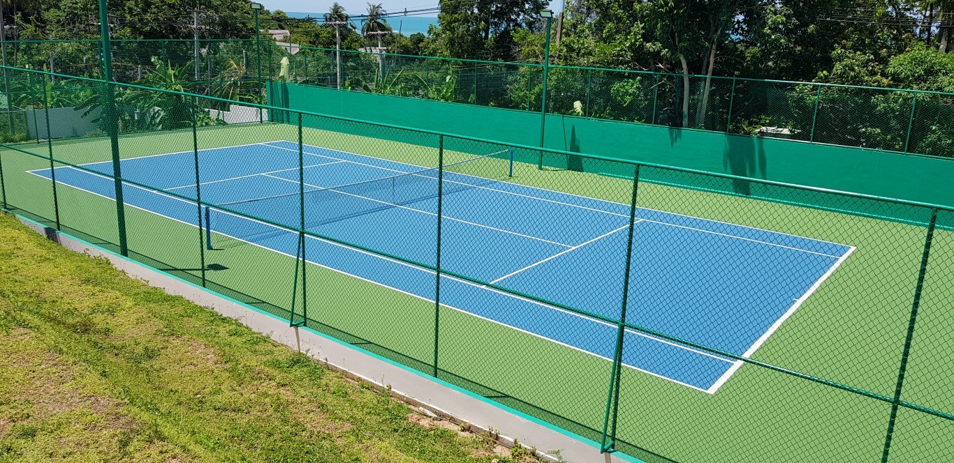 The floodlit tennis court inside the estate