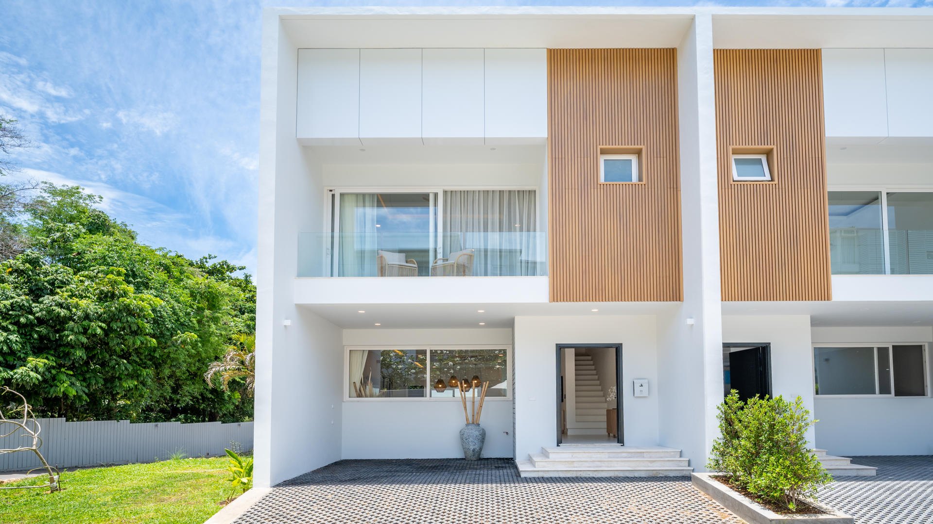 The townhouse frontage, timber panels between white render