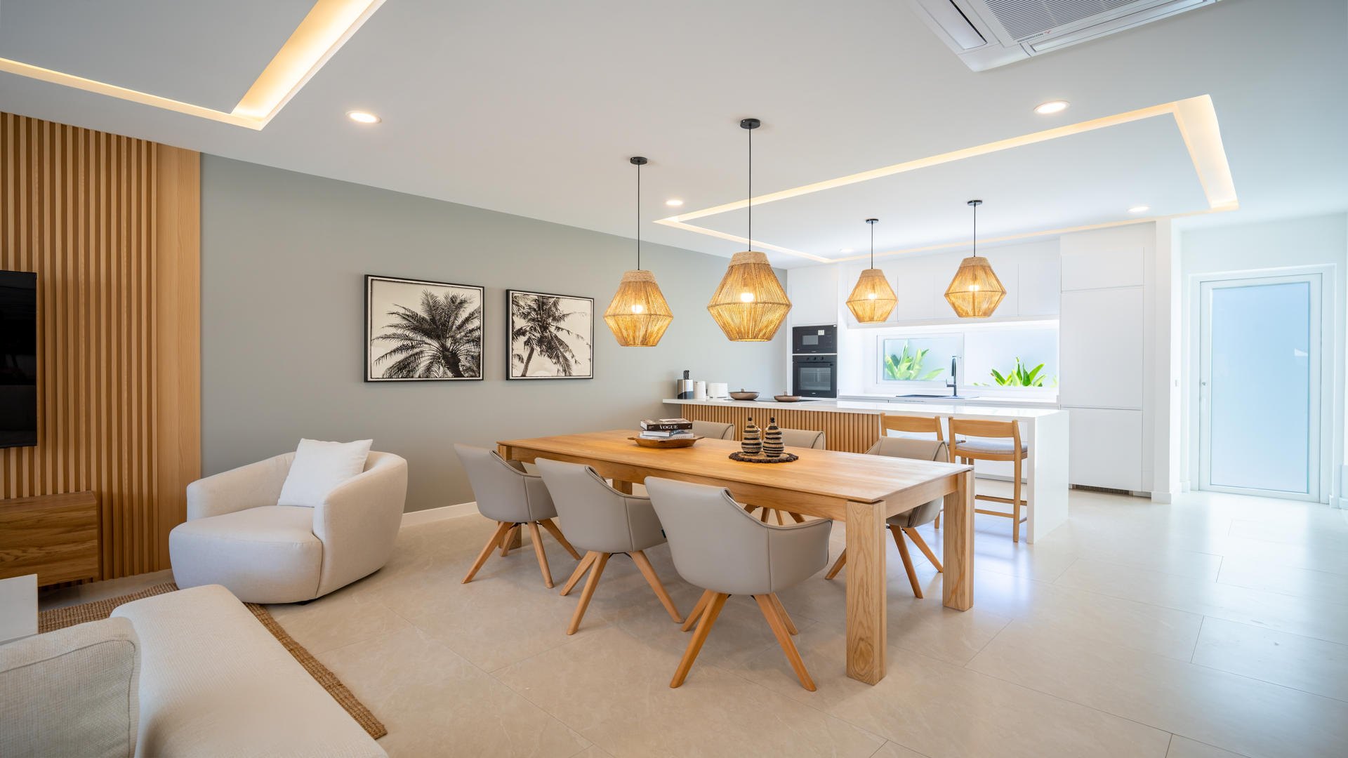 Dining table and the open kitchen behind it