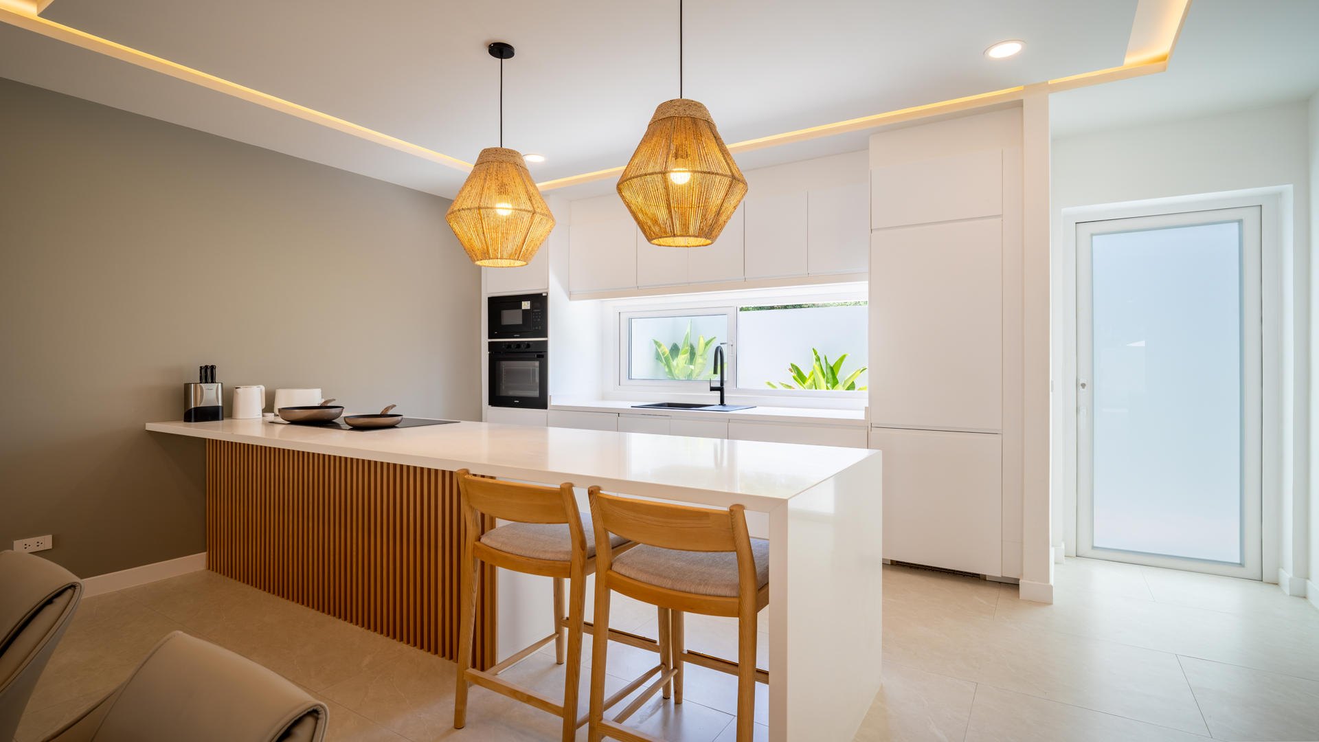 The fitted kitchen and its breakfast bar