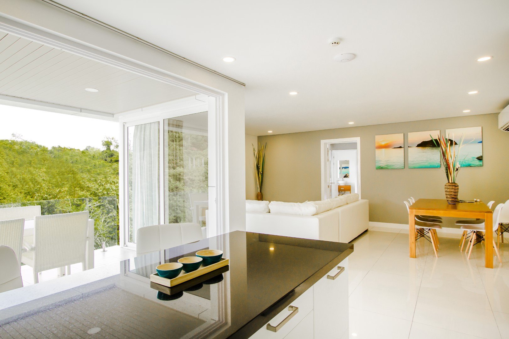 Kitchen island and dining area opening onto the balcony