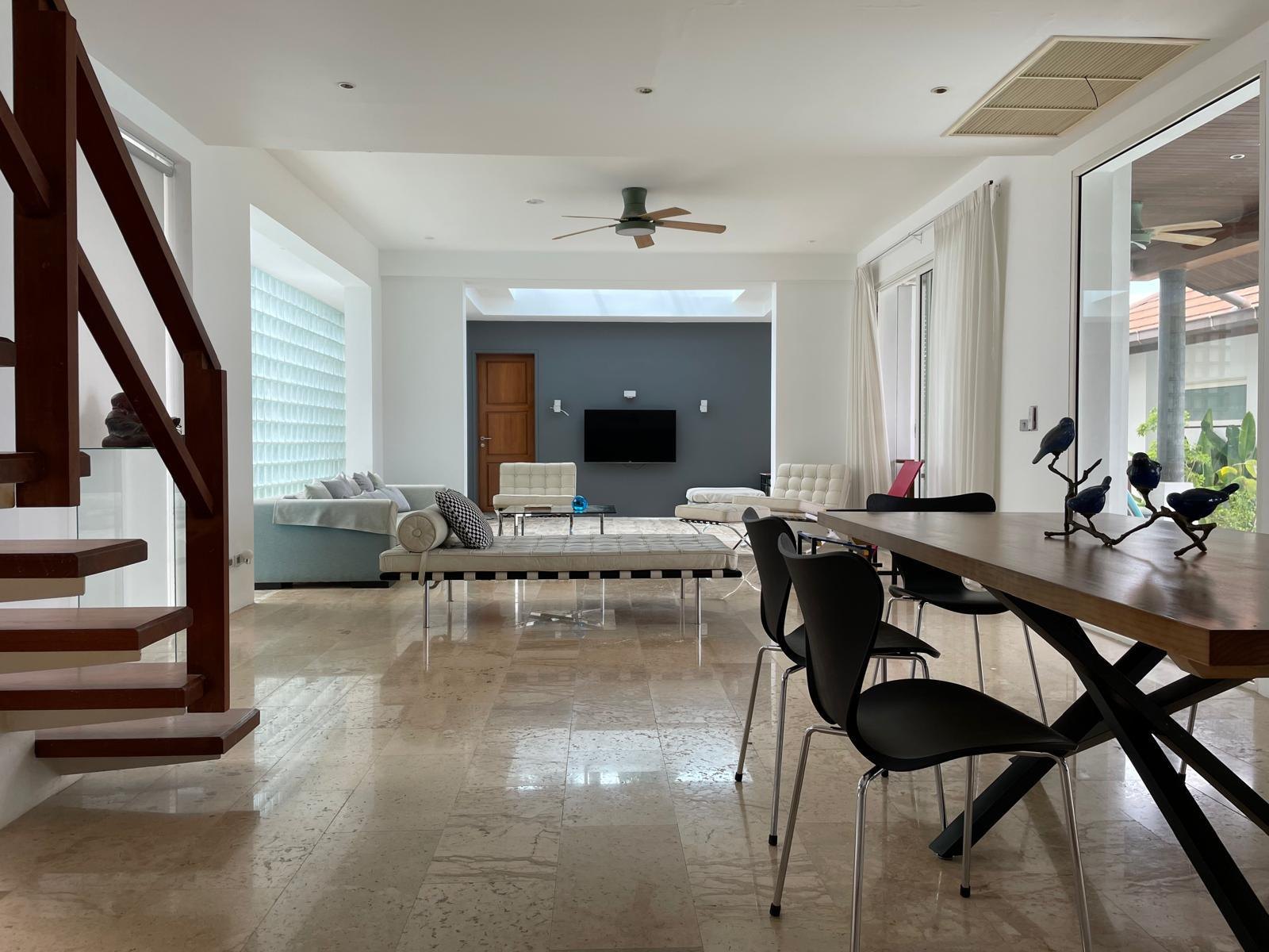 Living and dining space with the staircase behind