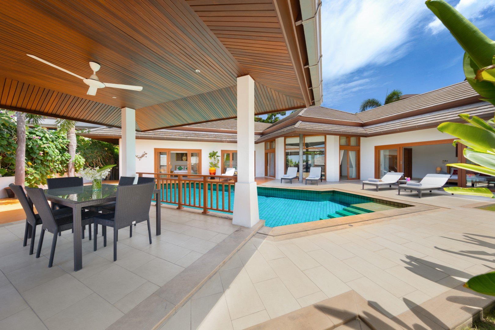 The covered terrace running along the pool