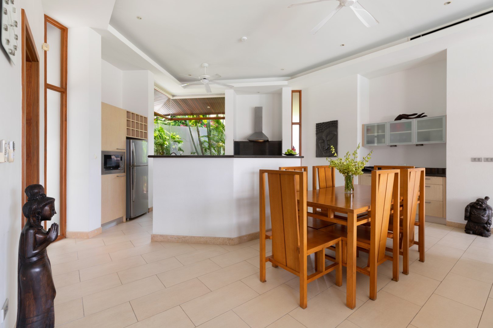 The dining table with the kitchen behind it