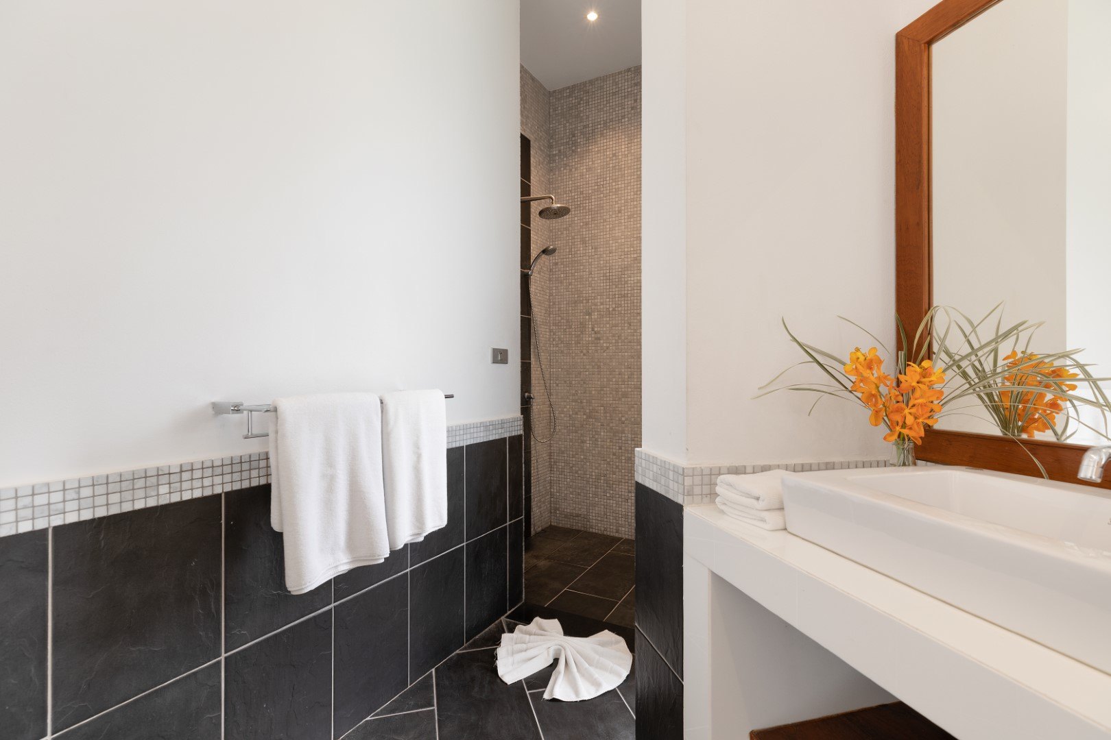An en-suite bathroom with a corner bathtub