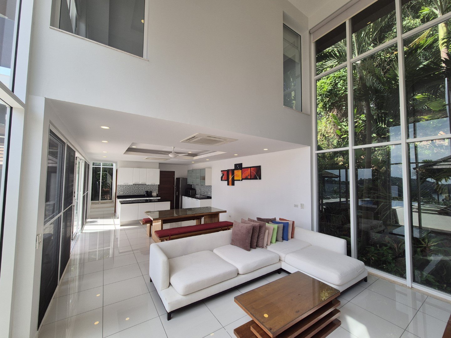 Living room with white sofas facing the glass