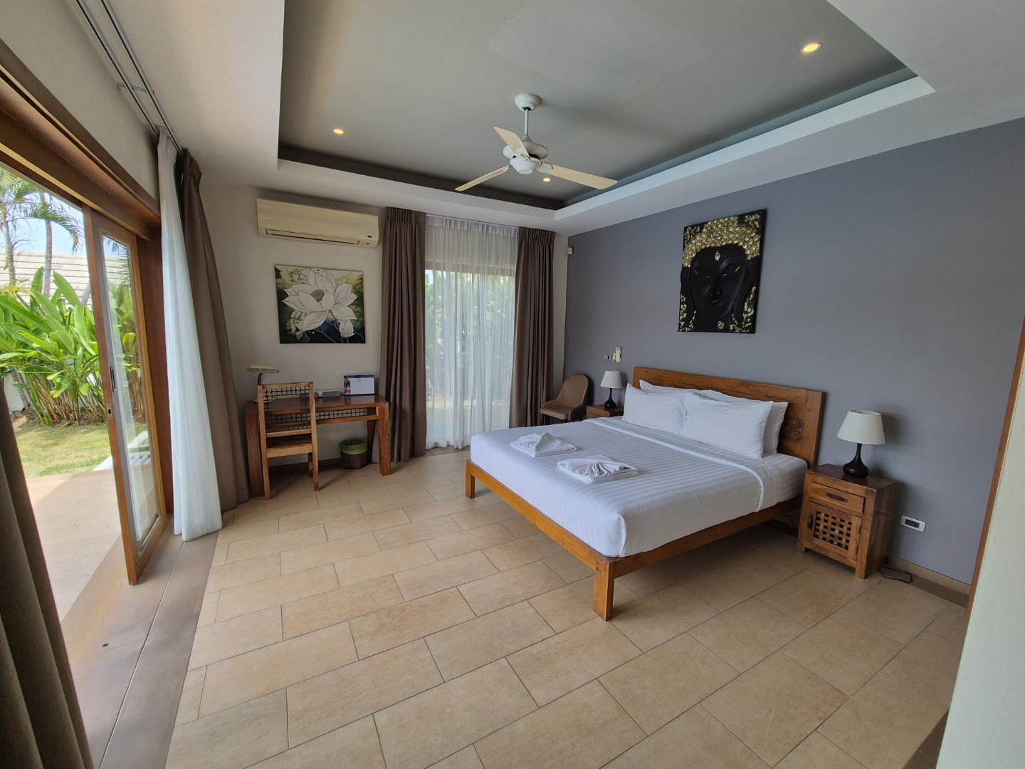 A bedroom with the garden outside the window