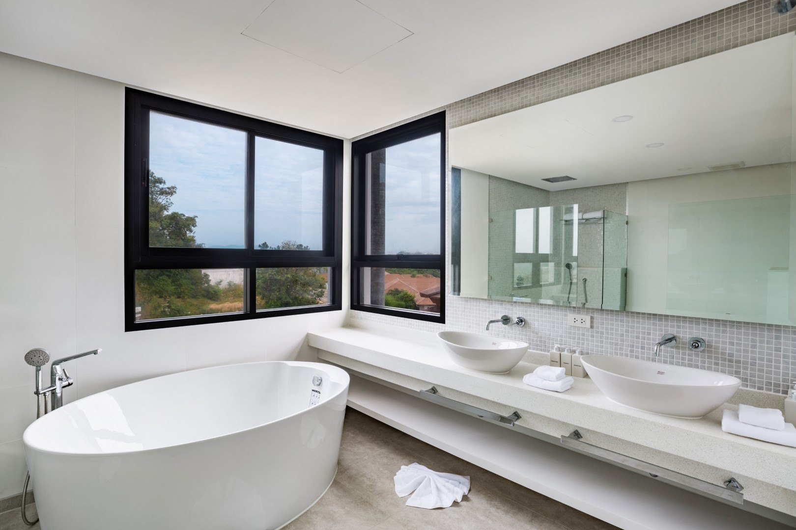 The master bathroom, freestanding tub against the view