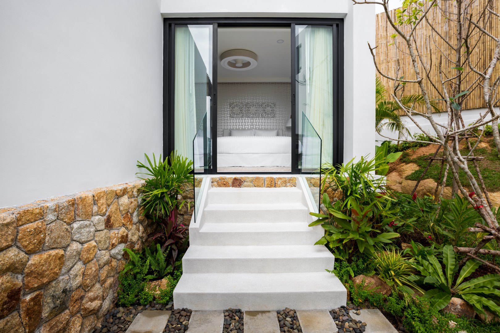 The entrance steps up through the planting