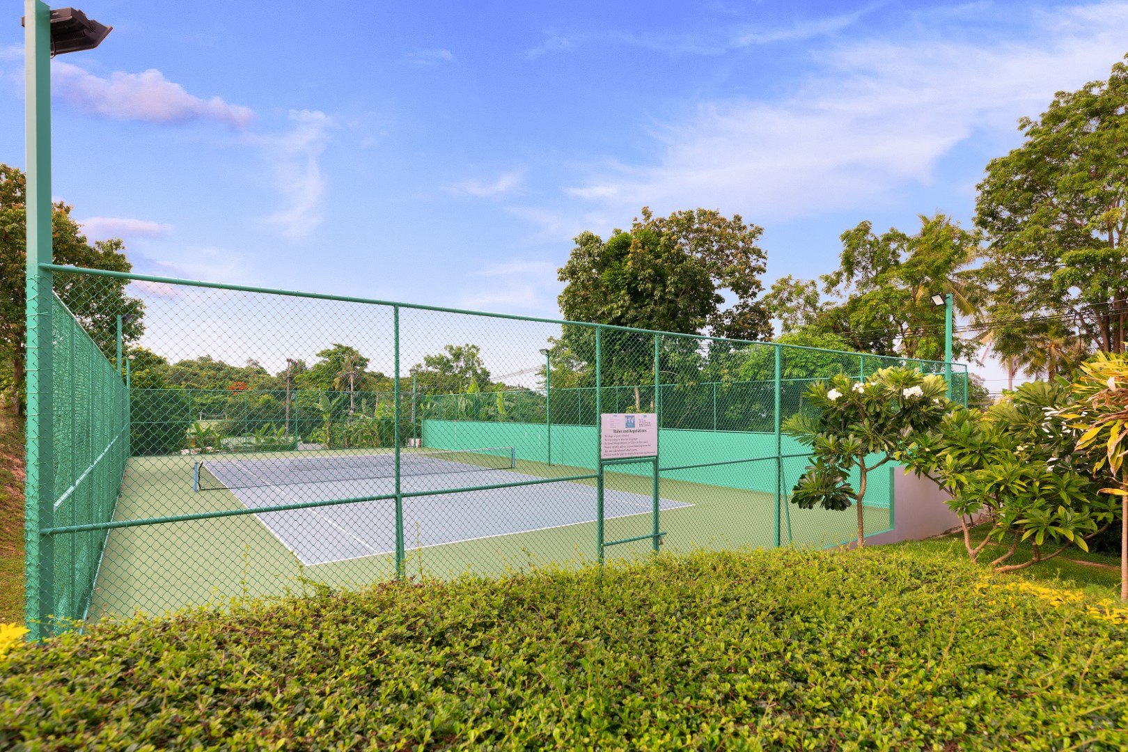 The floodlit tennis court inside the estate