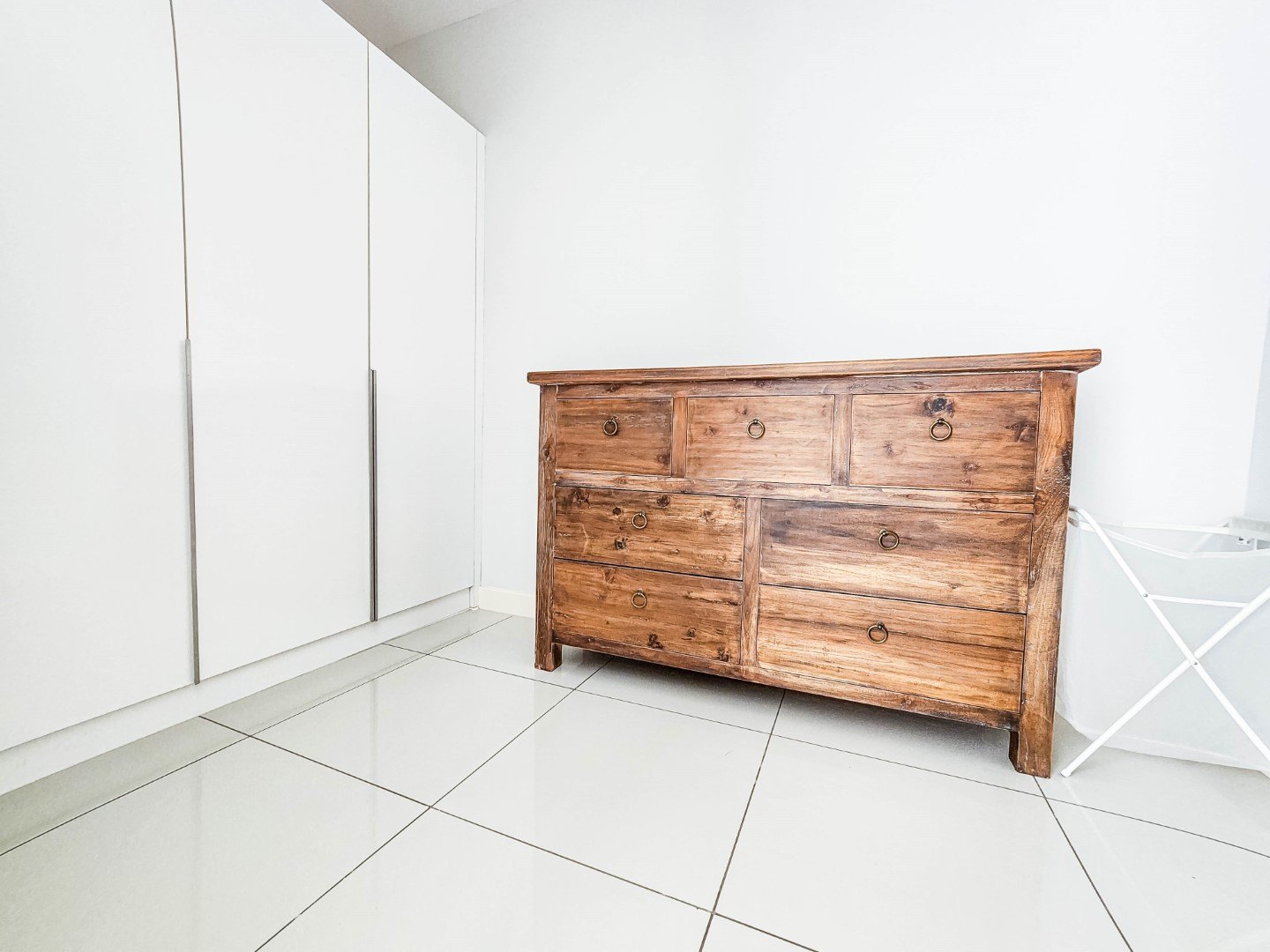 A bedroom with wardrobes along one wall