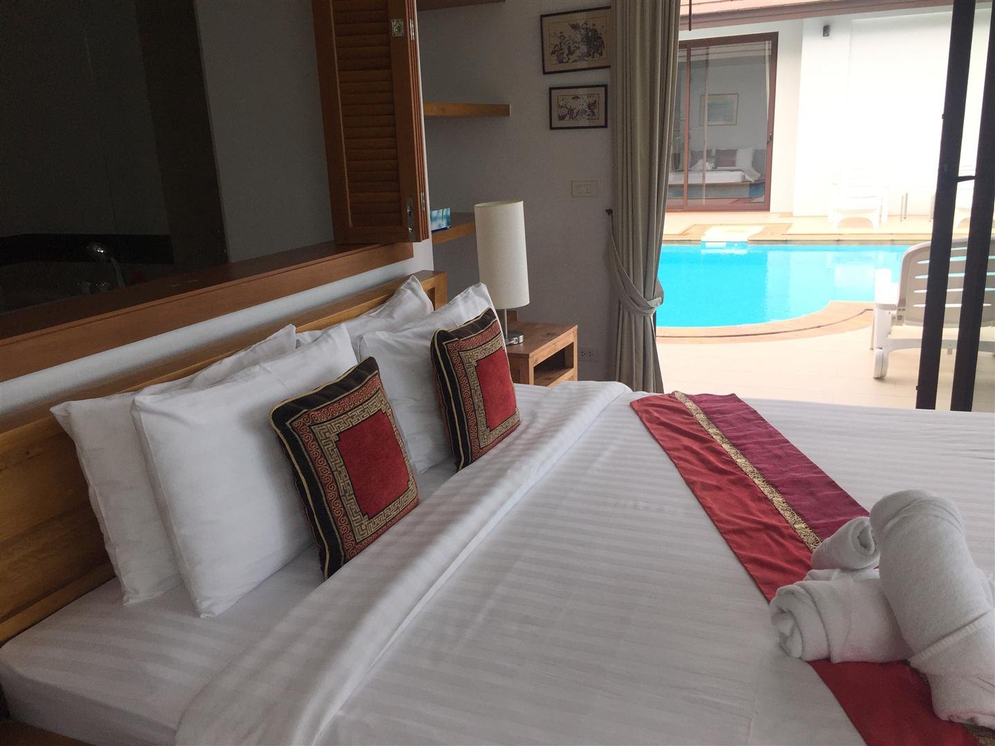 A bedroom with the jacuzzi bathroom beyond