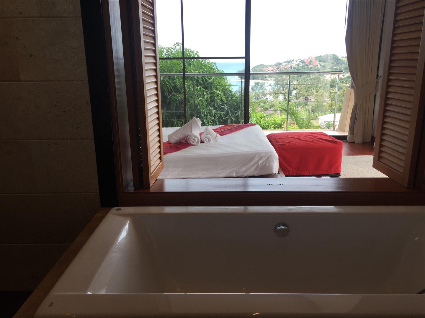 A bedroom opening to its own bathtub