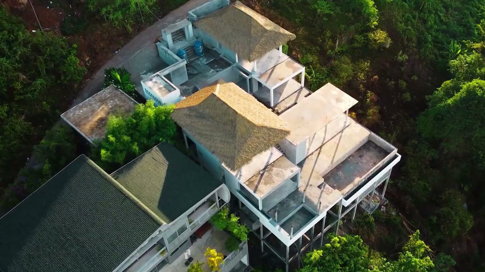 The villa from directly above, thatched pavilions and terraces
