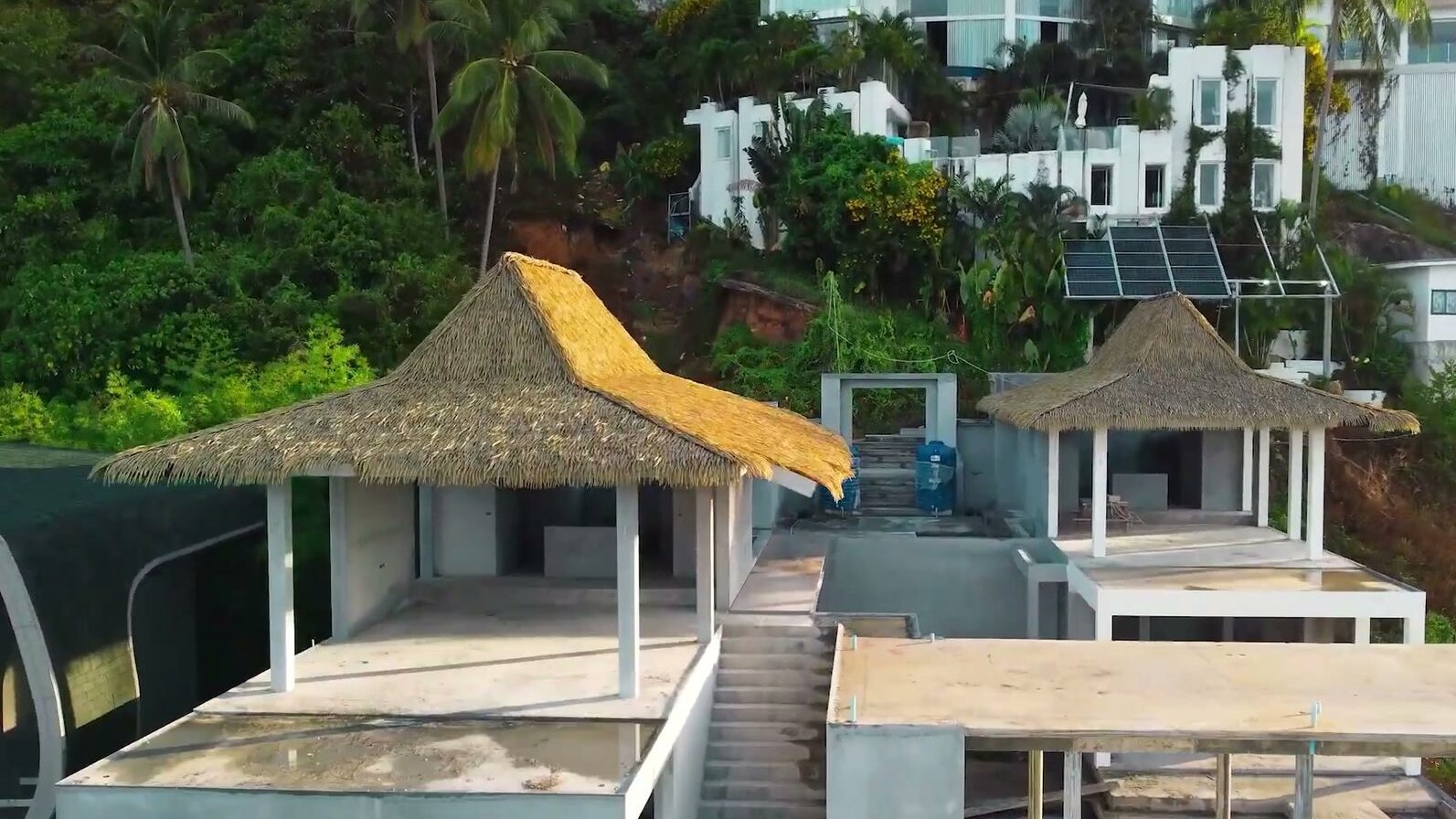 Separate pavilions stepping down the hillside, seen from the air