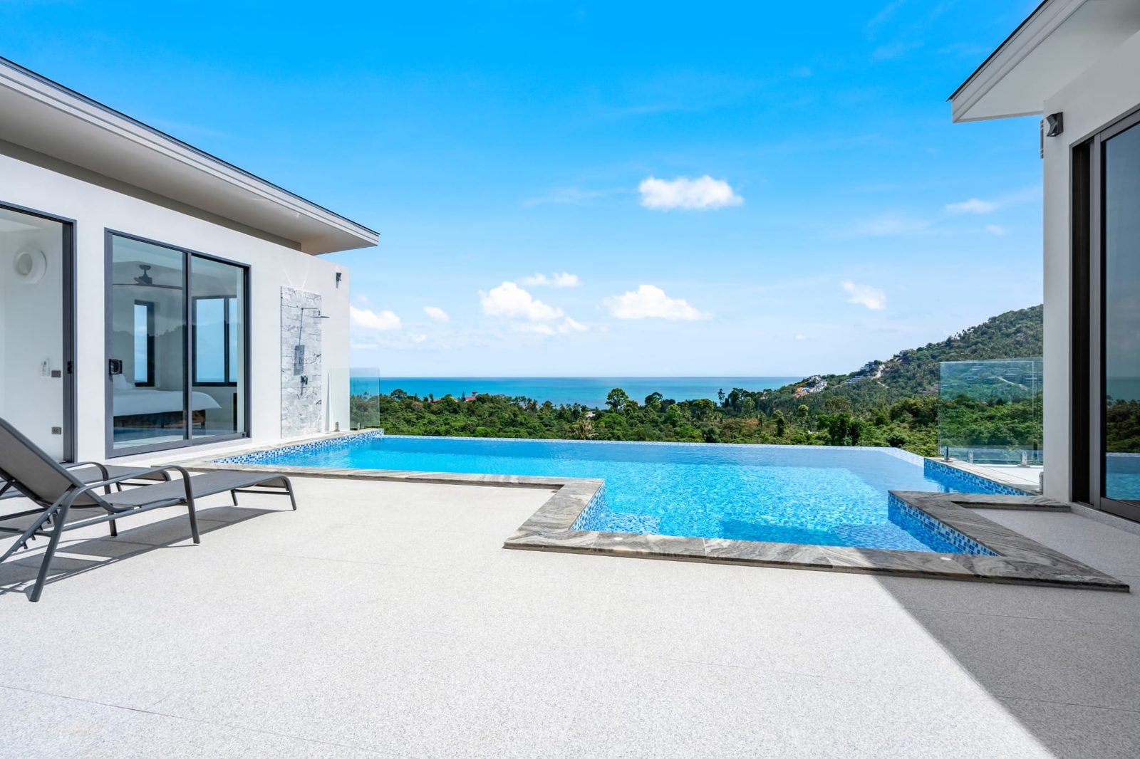 The pool deck, the villa and the sea beyond