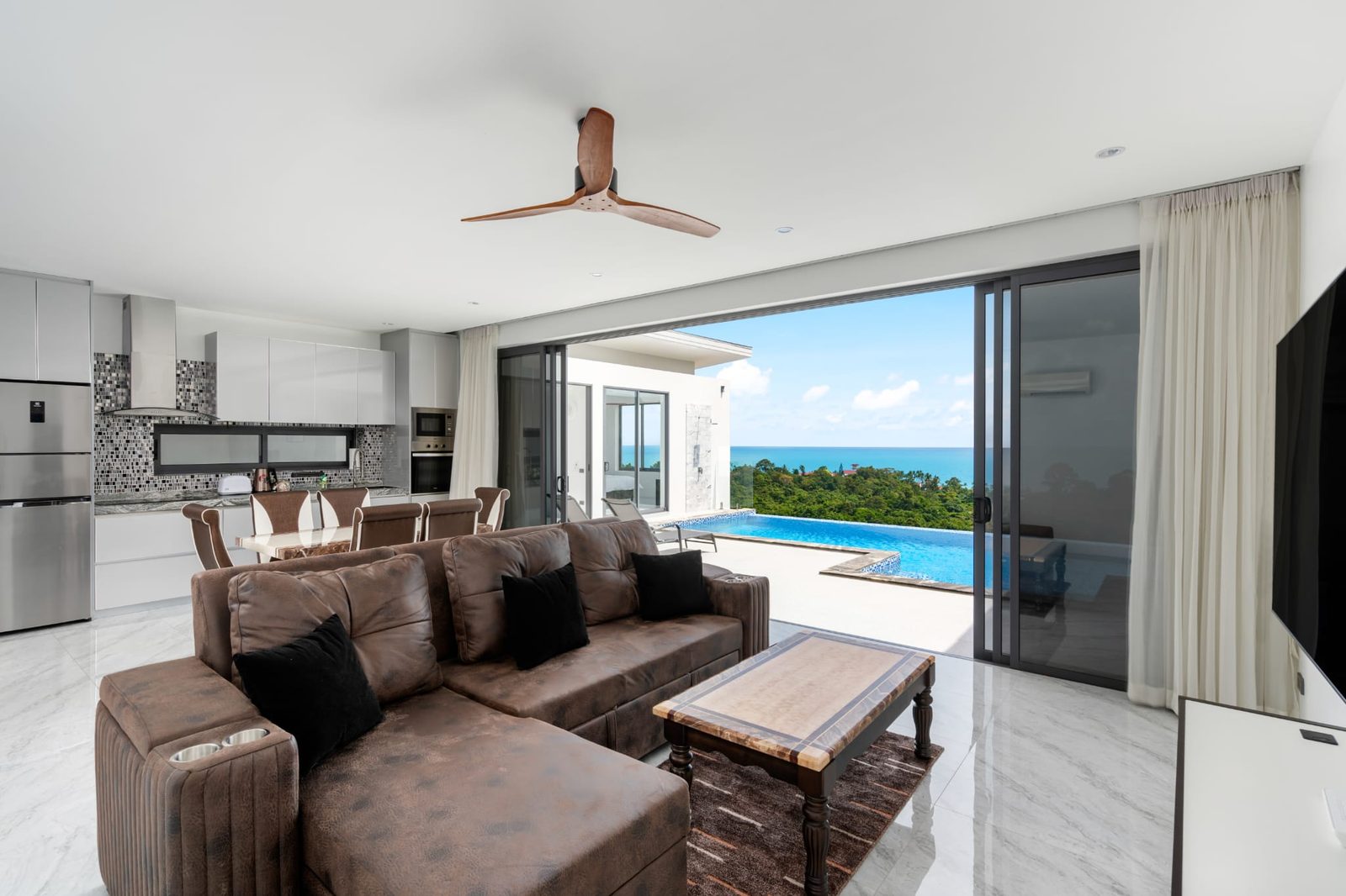 Open-plan living room and kitchen with the sea view